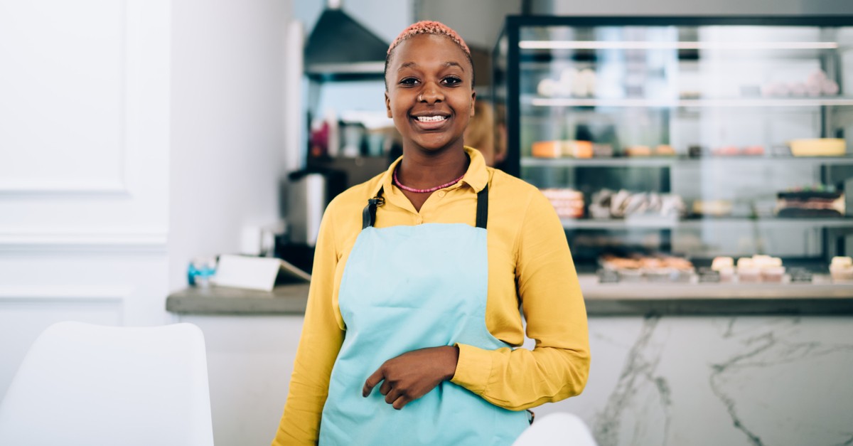 Friendly African American female in apron-img