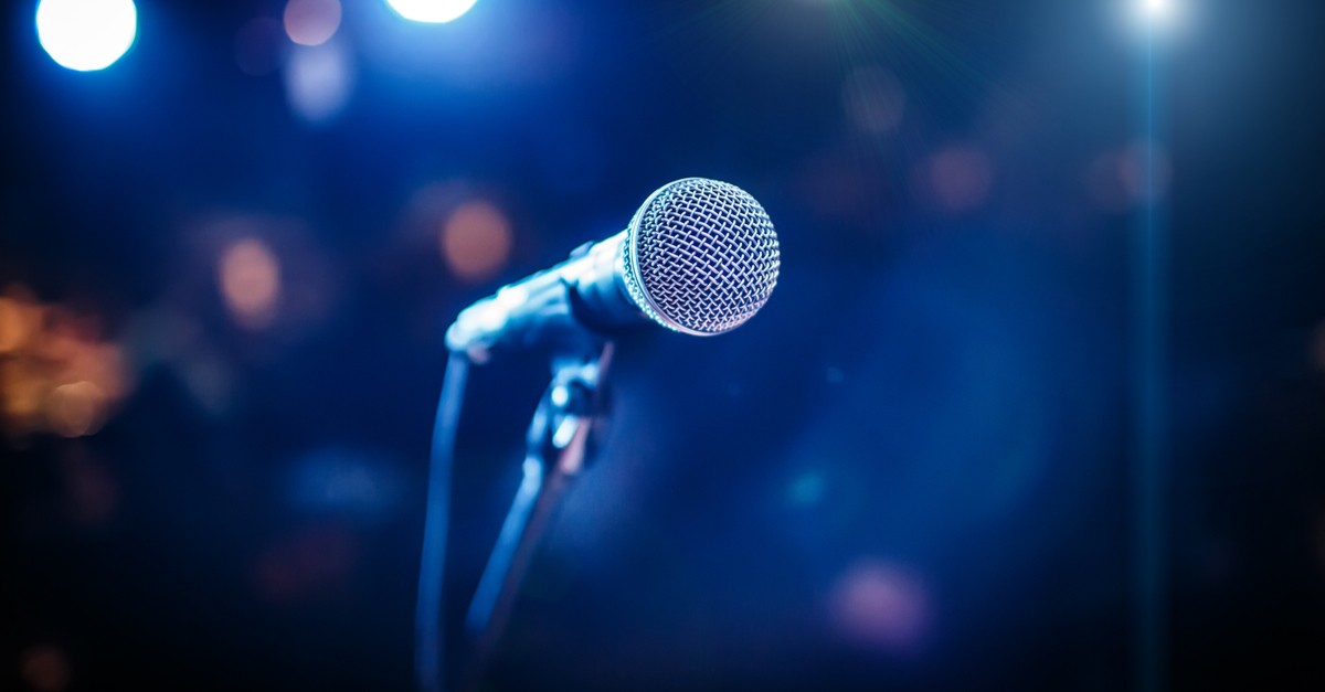 Microphone on stage against a background of auditorium-img