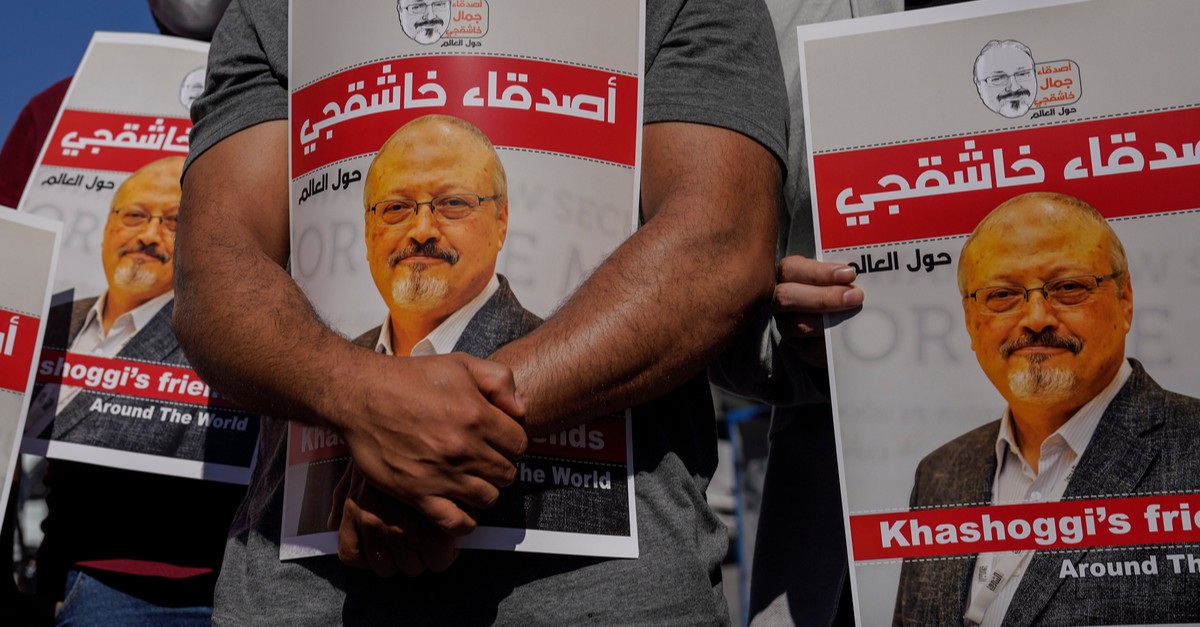 People hold pictures of Jamal Khashoggi during an event-img