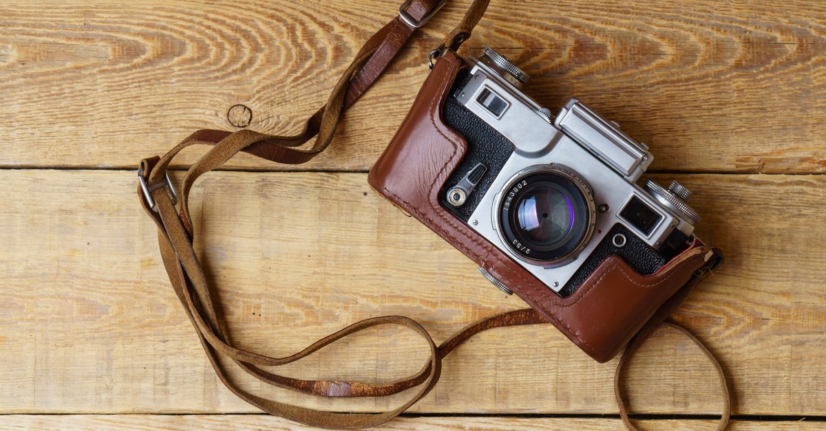 Old retro camera on vintage rustic wooden planks boards-img