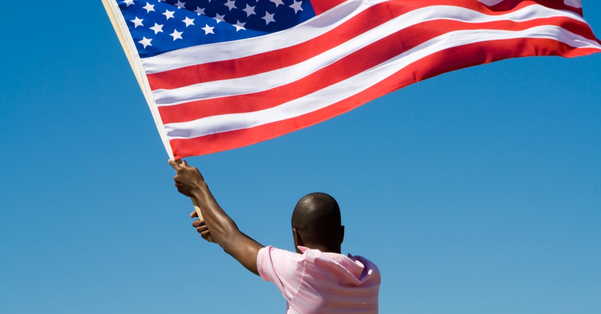 young african american man waving a USA flag-img