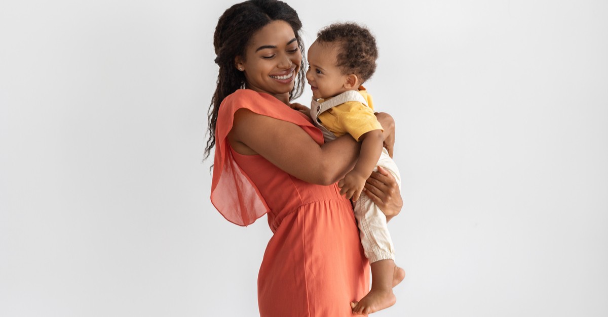 Young Black Mom With Infant Son On Arms-img