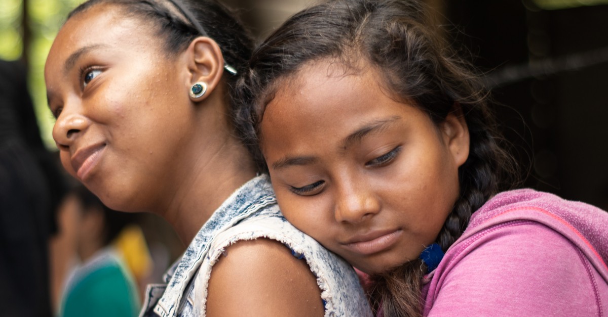 Two young Nicaraguan girls comfort each other-img