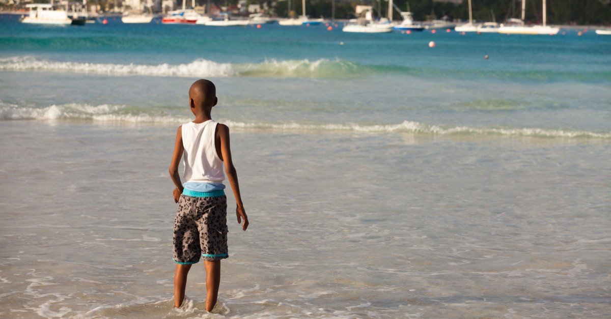 Young boy enjoying the beauty of a Barbados beach-img