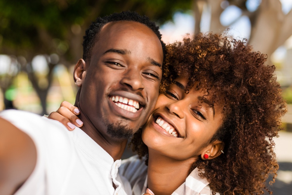 Outdoor protrait of black african american couple taking a selfie-img