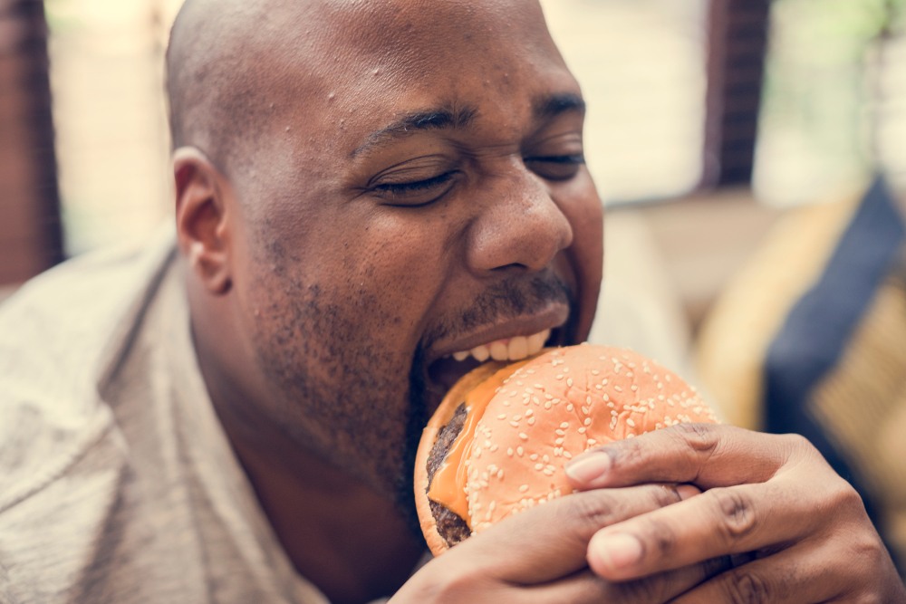 Man eating a big hamburger-img