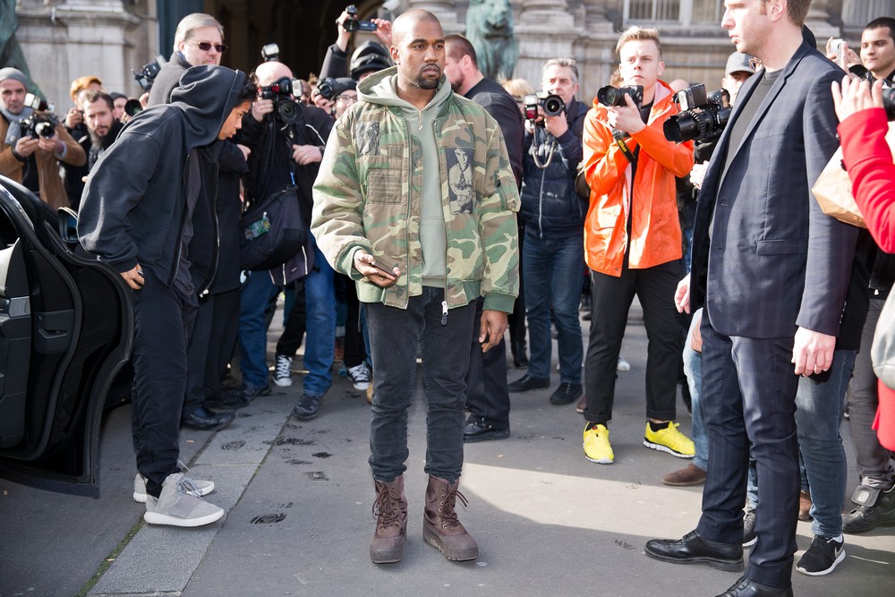 Kanye West posing for photographers in front of the Dries van noten fashion show-img
