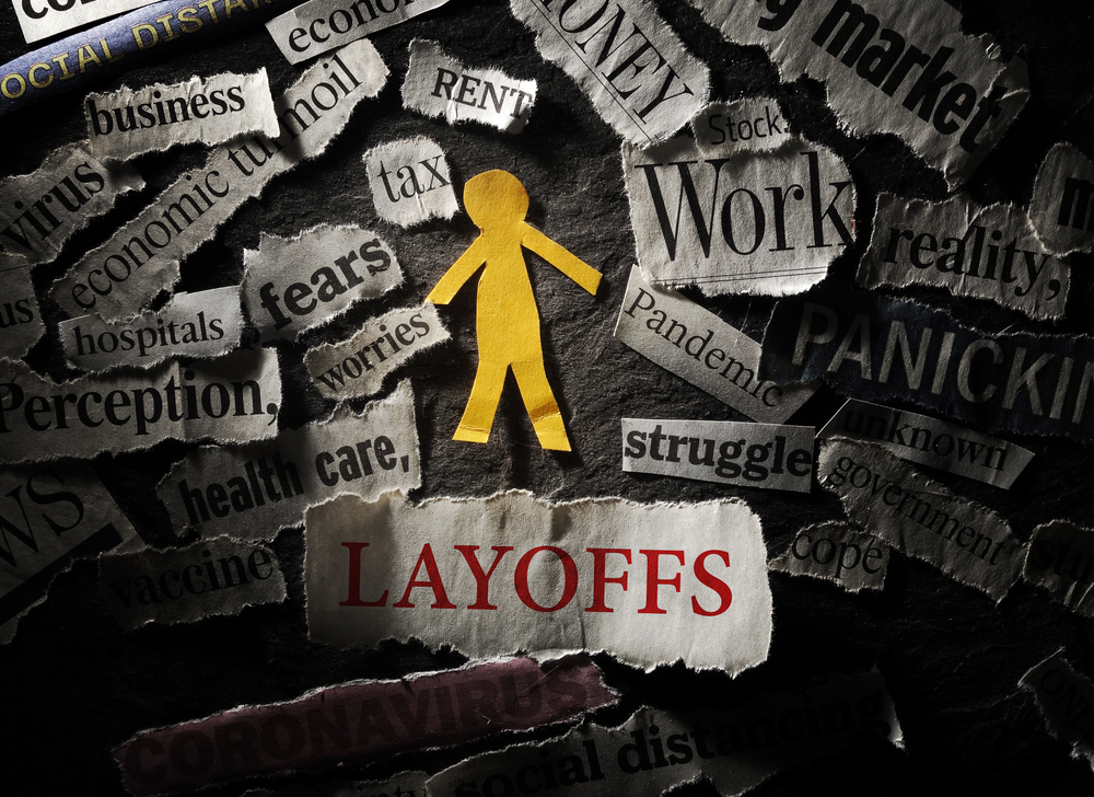 Paper,Cutout,Person,With,Layoffs,Headline,,Surrounded,By,Coronavirus,And