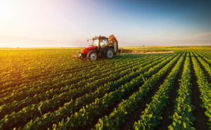 Tractor,Spraying,Pesticides,On,Soybean,Field,With,Sprayer,At,Spring