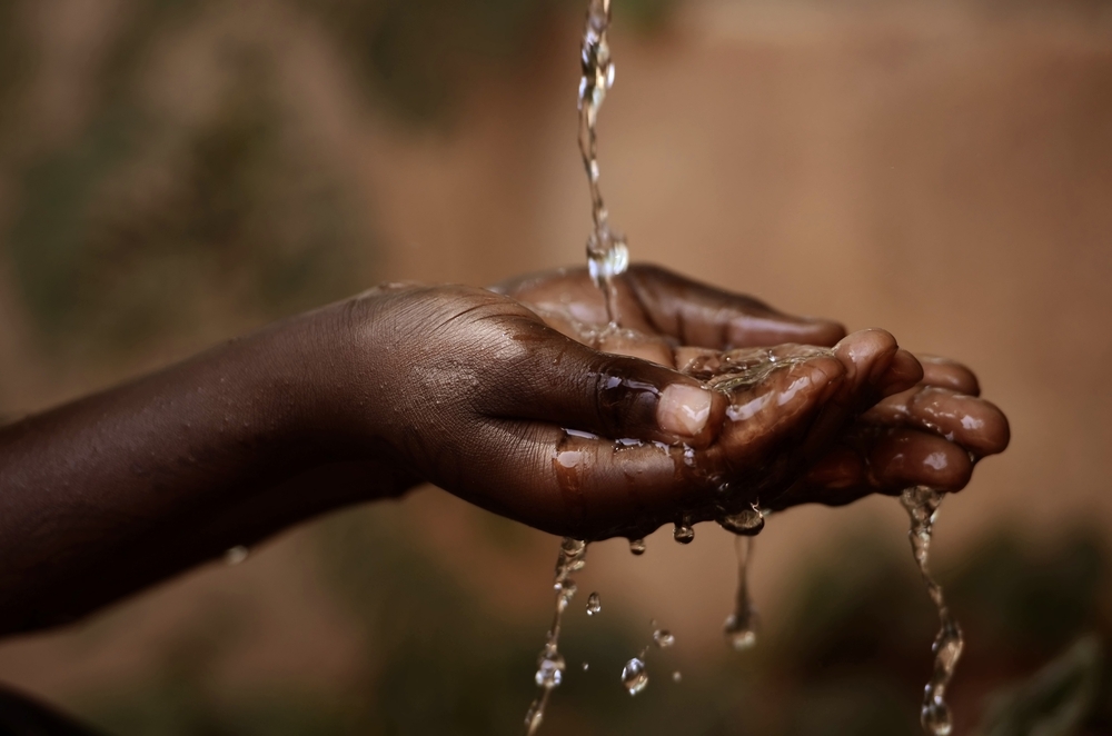Social,Issues:,Water,Pouring,In,African,Child’s,Hands