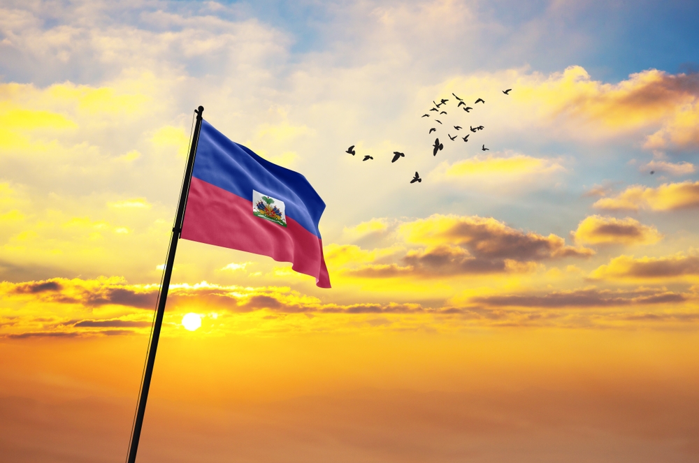 Waving,Flag,Of,Haiti,Against,The,Background,Of,A,Sunset