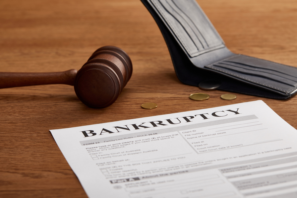 Bankruptcy,Form,With,Wooden,Gavel,,Coins,And,Wallet,On,Brown