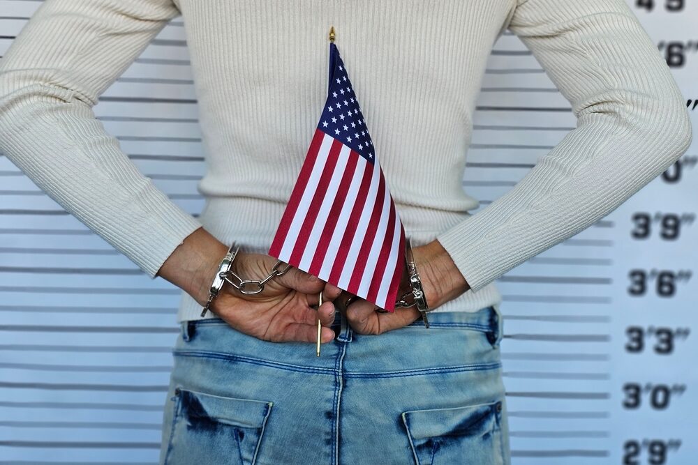 Handcuffed,Hands,Holding,An,American,Flag,At,A,Police,Station Handcuffed,Hands,Holding,An,American,Flag,At,A,Police,Station